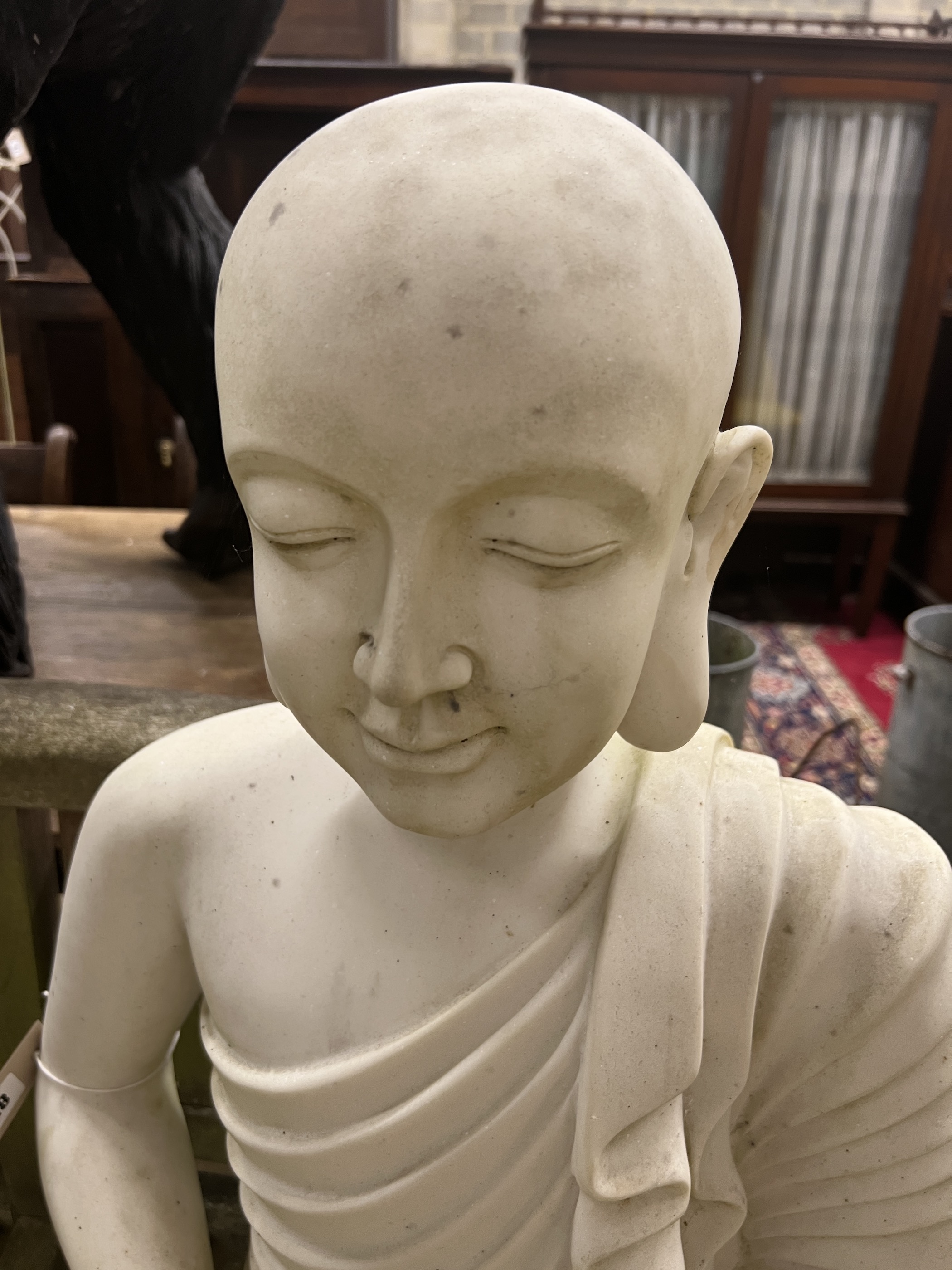 A composition faux marble seated Buddha garden ornament, height 74cm